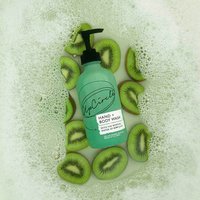 Green UpCircle hand and body wash bottle with pump, surrounded by kiwi slices and bubbles.