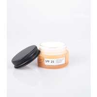UpCircle SPF 25 mineral sunscreen in a small amber jar with black screw cap, white label detailing product information.