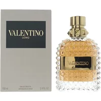 Valentino Uomo Eau De Toilette 100ml, clear studded bottle with gold cap, next to gray box with black label.
