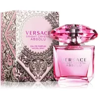 Pink Versace Bright Crystal Absolu perfume bottle with faceted cap, next to ornate pink and silver box.