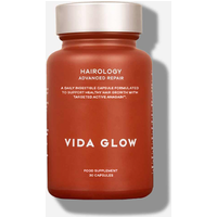 Rust-colored Vida Glow Hairology bottle with white text, silver cap, containing 30 capsules for hair health.