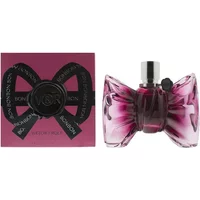 Pink bow-shaped Viktor&Rolf Bonbon perfume bottle with silver cap, next to matching pink box with black ribbon design.