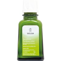 Green glass bottle of Weleda Aknedoron Purifying Lotion with white cap and green label, 50ml size.