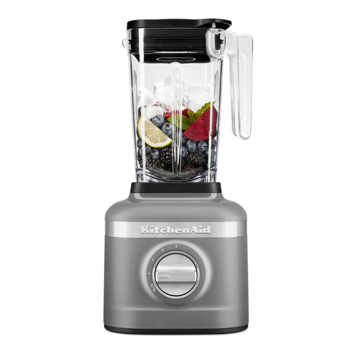 Charcoal grey KitchenAid K150 Blender with a 1.4L clear pitcher filled with ice, berries, and lemon, featuring a silver control dial on the base.