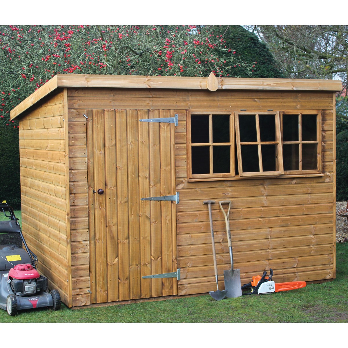 Traditional heavy-duty wooden shed with a pent roof, featuring a natural wood finish, a single door with a latch, two windows, and tools leaning against the side on a grassy area.