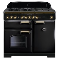 Classic Deluxe 100cm dual fuel range cooker in black with brass trim, featuring six gas burners, two ovens, and a sleek design with elegant knobs and handles.