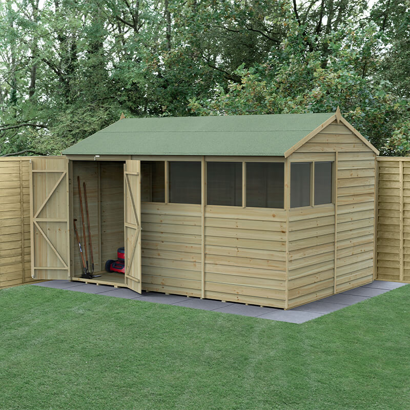 12' x 8' wooden shed with a green apex roof, featuring double doors, six windows, and pressure-treated timber, set against a backdrop of greenery and grass.