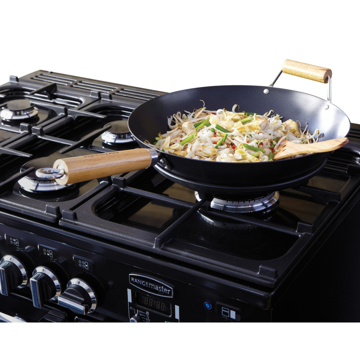 Black and chrome Rangemaster PDL90DFFCBC dual fuel range cooker with five gas burners and a large wok pan filled with stir-fried vegetables on the stovetop.