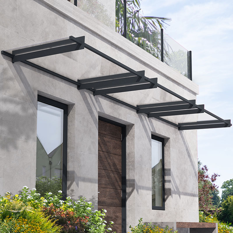 Grey 15' x 3' Palram Canopia Nancy 4500 door canopy featuring a sleek design with sturdy metal brackets, mounted above a wooden door, enhancing outdoor protection and aesthetics.