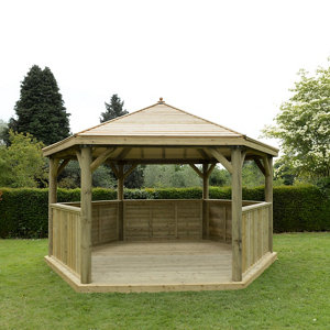 Large hexagonal wooden gazebo with a sloped roof, natural timber finish, open sides, and a spacious deck floor, designed to seat up to 19 people in a garden setting.