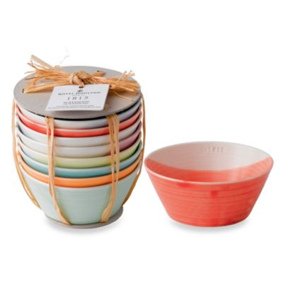 Set of 8 porcelain bowls in various pastel colors, featuring a smooth finish and a contemporary design, stacked and tied with natural twine for presentation.