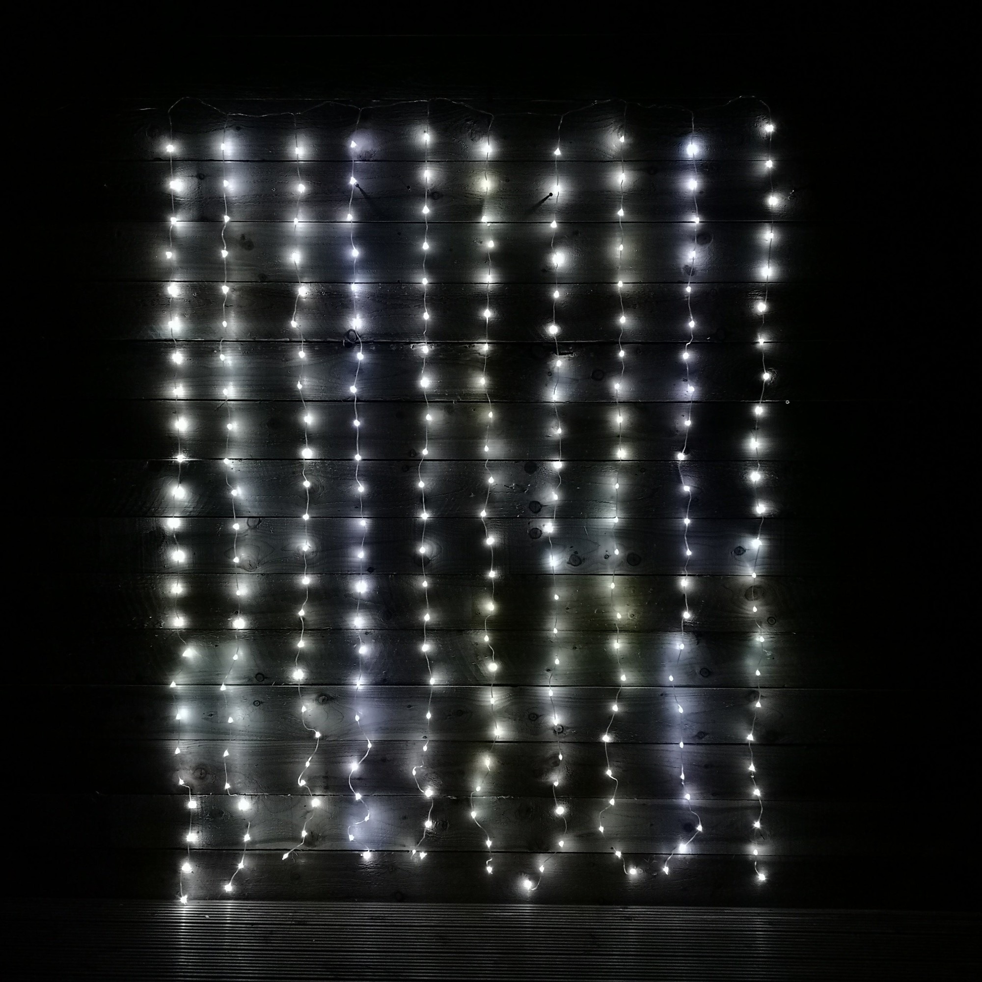 240 LED curtain lights in white, measuring 2m x 1.5m, hanging vertically with multiple strands, suitable for indoor or outdoor use, featuring a timer function.