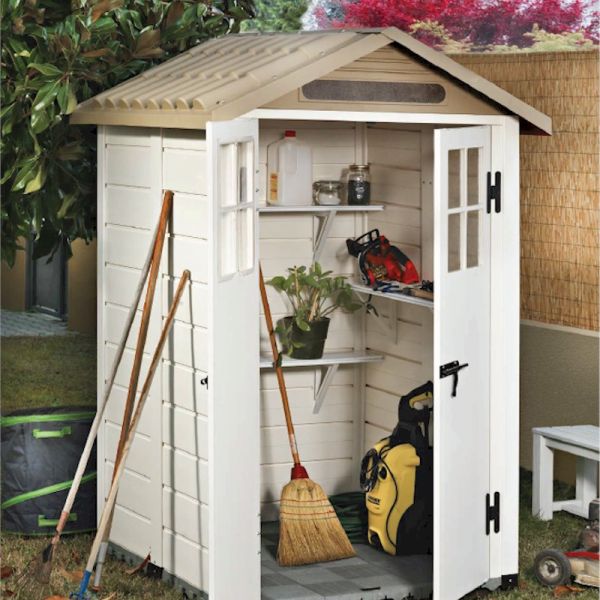 Compact 4' x 4' white plastic garden storage shed with a beige sloped roof, featuring double doors, shelves inside, and tools leaning against the exterior.