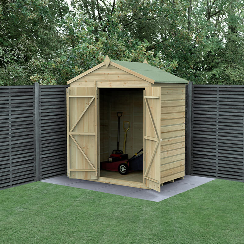 Wooden apex shed with a green felt roof, featuring double doors, shiplap design, and pressure-treated timber, set against a backdrop of wooden fencing and grass.