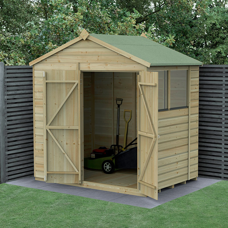 A wooden shed with a green apex roof, featuring double doors, shiplap design, and a natural wood finish, set against a backdrop of dark wooden fencing and greenery.