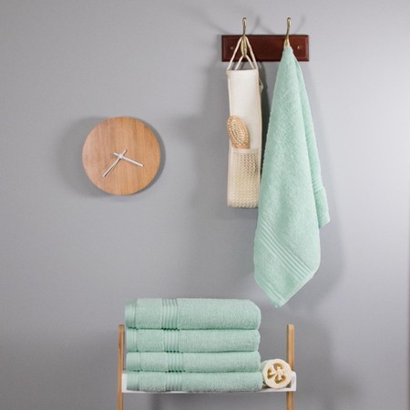 Soft duck egg blue bamboo hand towel, 700 GSM, measuring 47cm x 85cm, displayed hanging on a wall alongside a wooden clock and other towels.