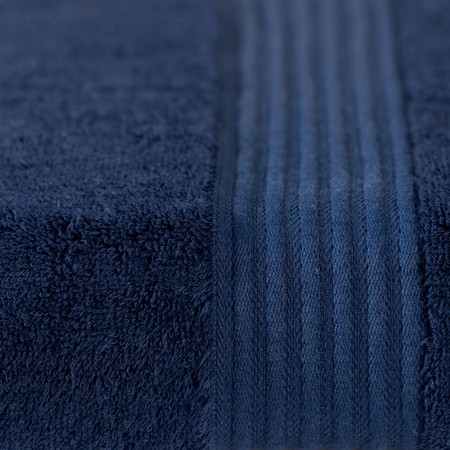 Navy blue bath sheet made from 700 GSM bamboo, featuring a soft, plush texture and subtle striped detailing along one edge.