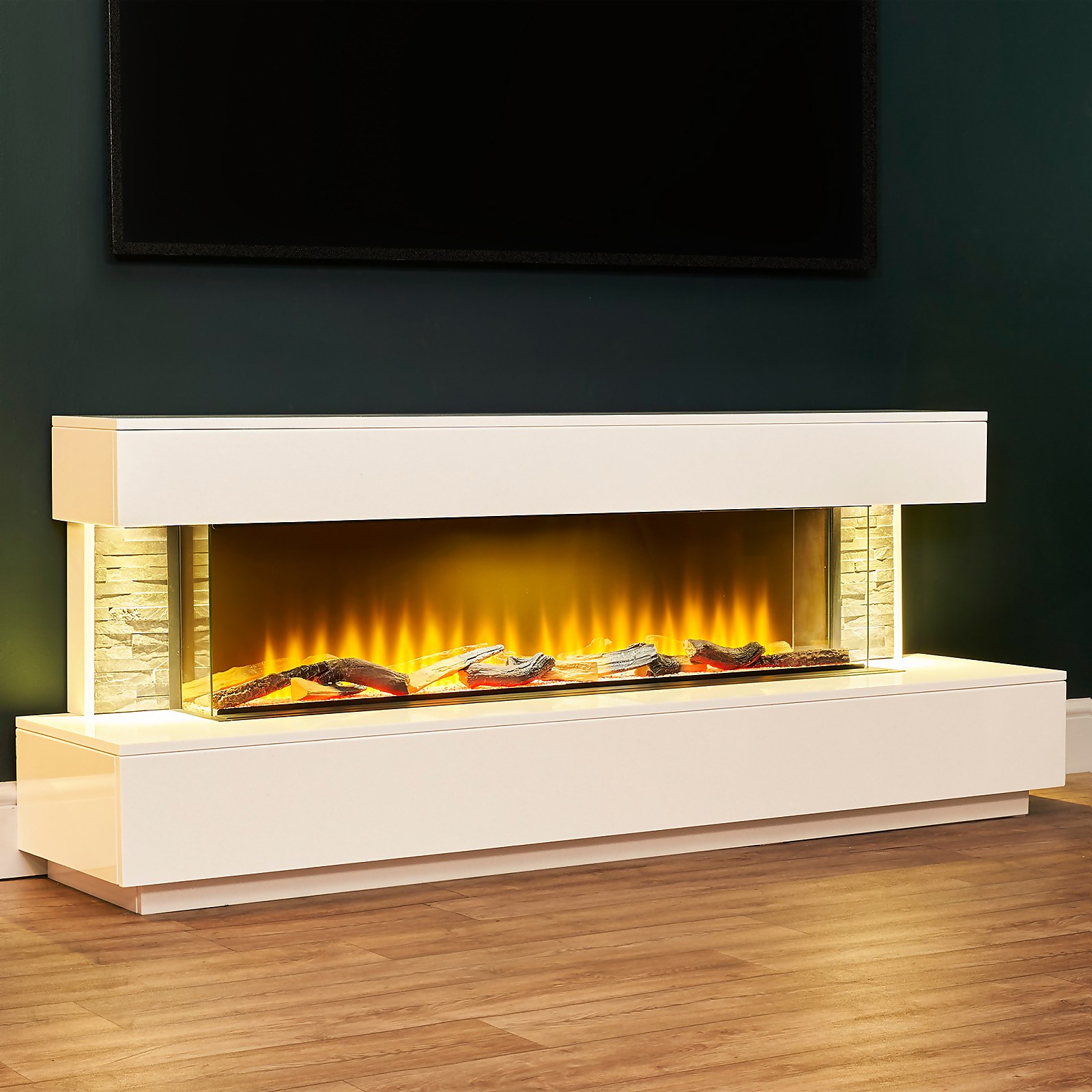 Acantha Aspen white marble and slate fireplace suite features downlights, a sleek design, and an illuminated flame effect, set against a dark wall and wooden floor.