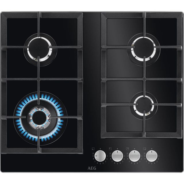 Black glass gas hob with four burners, featuring a blue flame on the central burner, stainless steel control knobs, and a sleek, modern design.