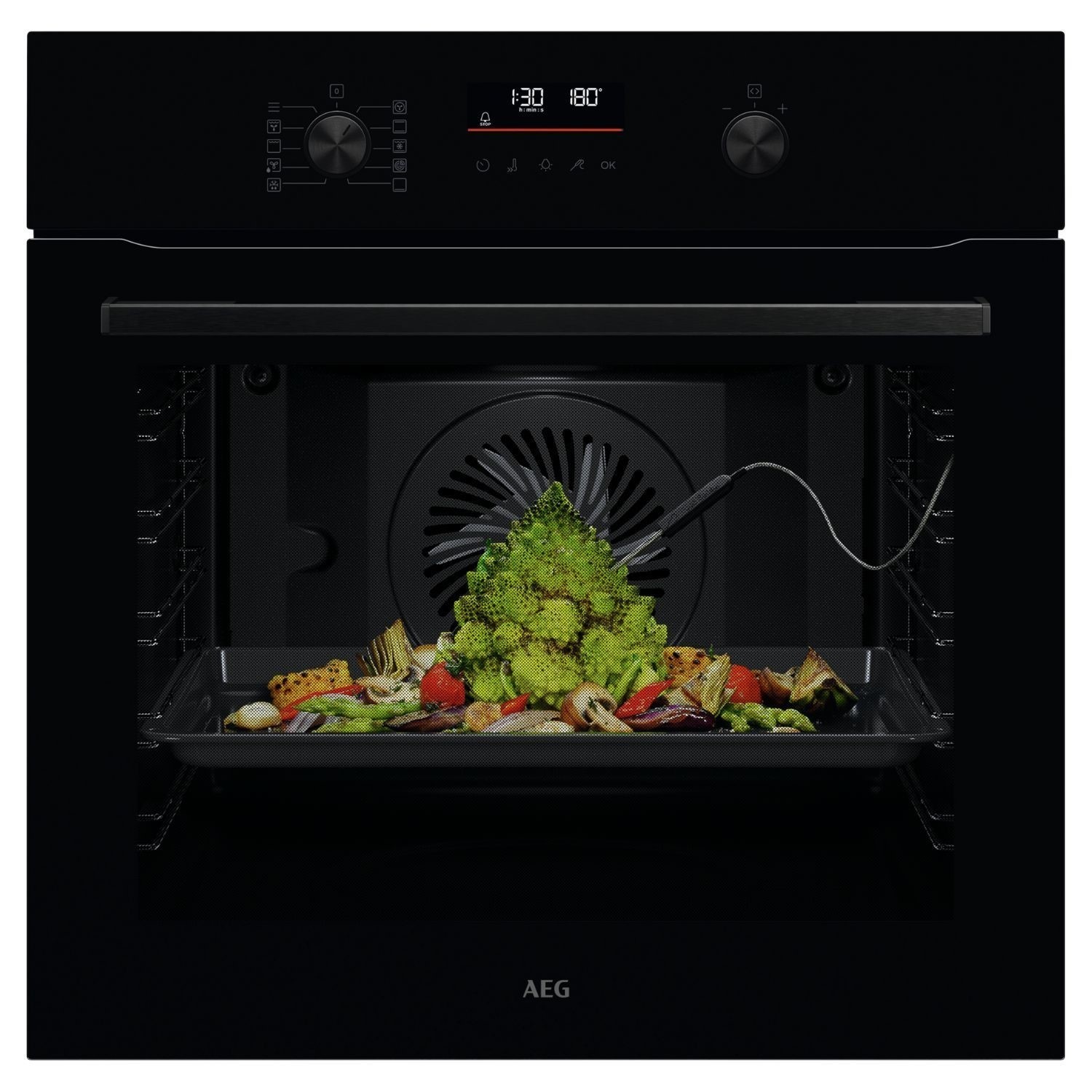 Black AEG 6000 Series OS6AB50AK electric built-in single oven featuring retractable dials, digital display, and a tray with colorful roasted vegetables inside.