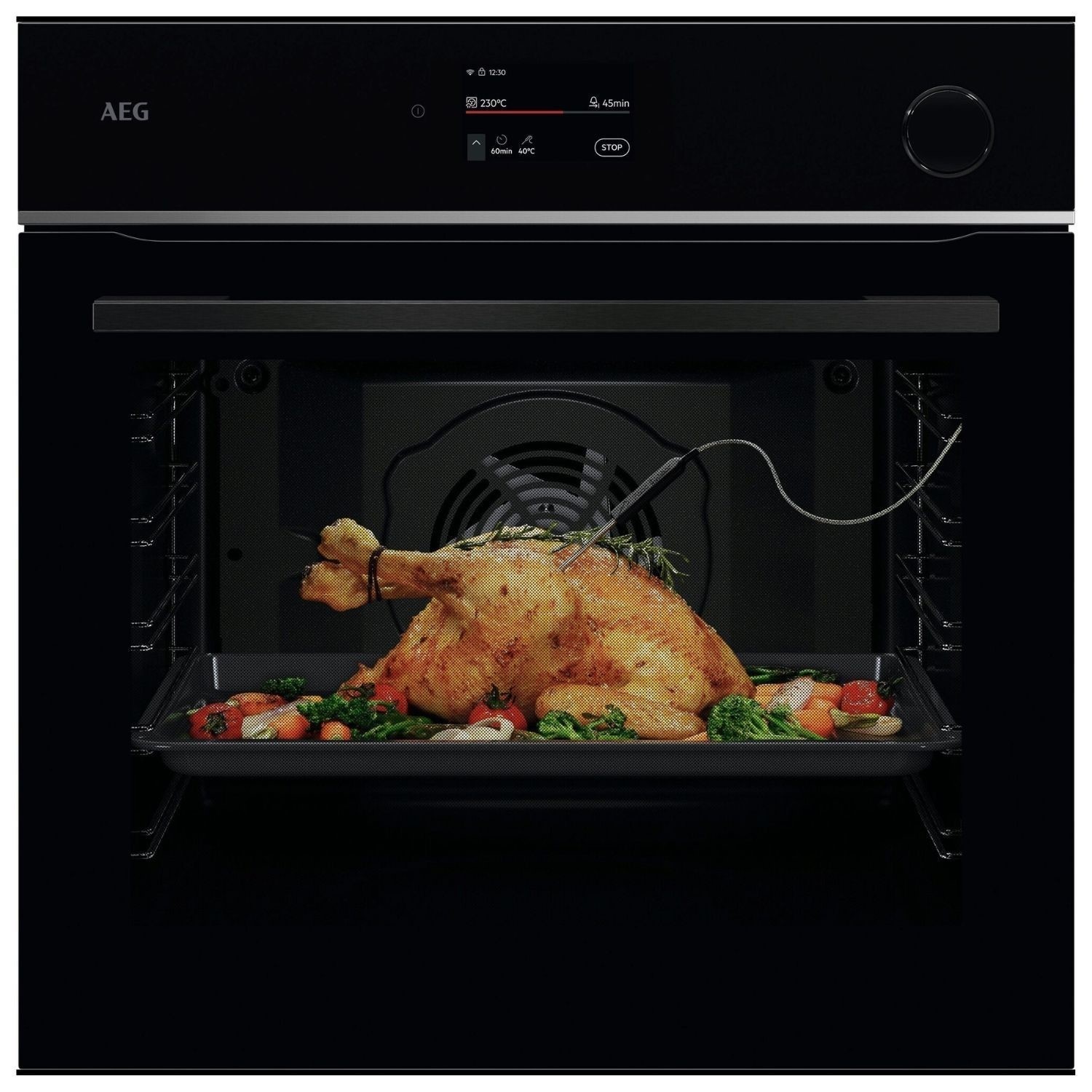 Built-in electric single oven in sleek black finish, featuring a digital display, pyrolytic cleaning function, and a roast chicken with vegetables inside.