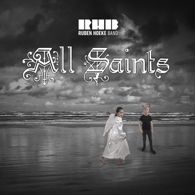 A black and white album cover featuring a beach scene with a child in an angel costume and another in dark clothing, under a cloudy sky, with ornate text reading "All Saints."