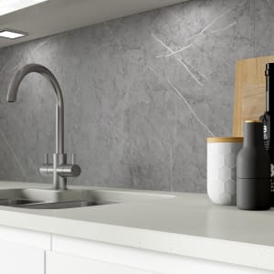 Grey marble splashback with a textured finish, measuring 3050 x 25 x 610mm, complements a modern kitchen with stainless steel faucet and stylish containers.