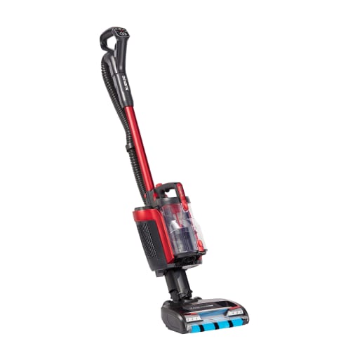 Shark ICZ300UK cordless upright vacuum cleaner in red and black, featuring PowerFins, a transparent dust container, and a powered lift-away design for versatile cleaning.