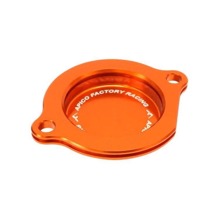 Orange anodized aluminum oil filter cover with a circular design, featuring two mounting holes and "APICO FACTORY RACING" engraved on the surface.
