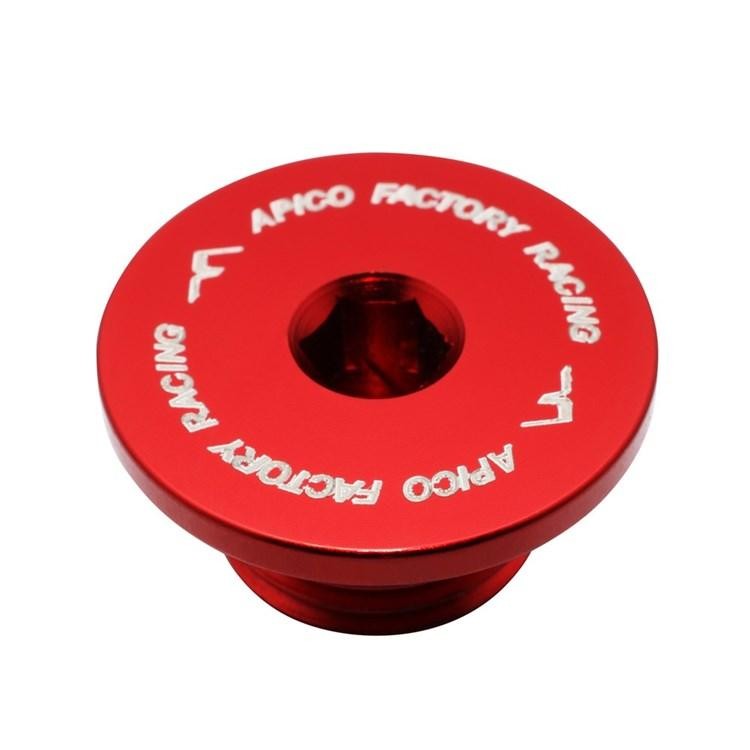Red aluminum oil timer plug with "APICO FACTORY RACING" engraved in white, designed for Montesa 4RT models from 2005 to 2023, featuring a central hexagonal opening.