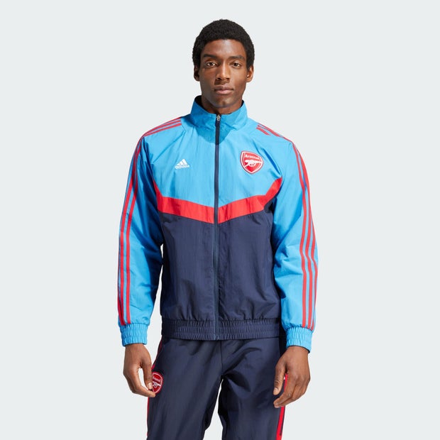 Blue Adidas Arsenal Woven Track Top featuring red stripes, a zip front, and the Arsenal logo on the chest, made from lightweight material suitable for casual wear or sports.