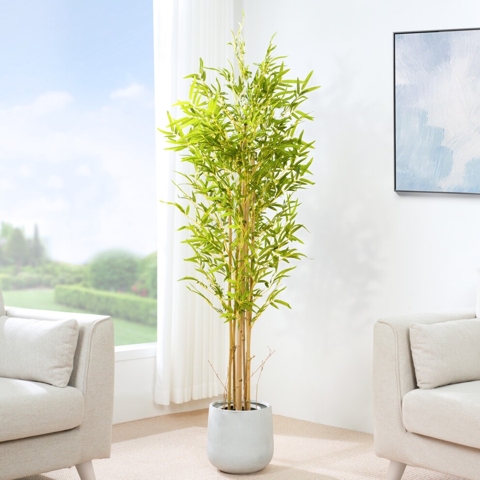 Lifelike 160CM artificial bamboo tree with vibrant green leaves, set in a gray plastic planter adorned with moss, positioned near a bright window.