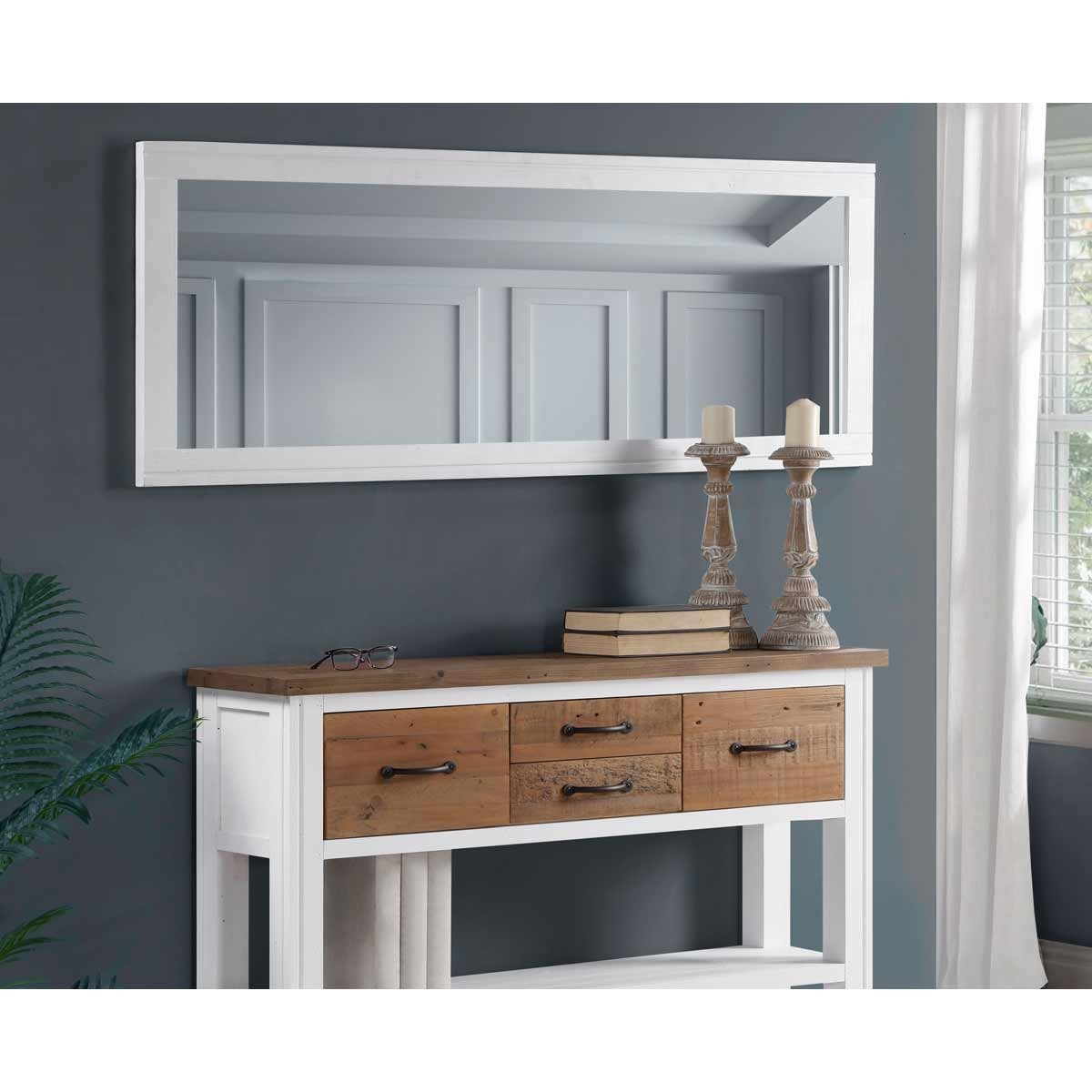 Extra long white wall mirror with a sleek frame, designed for landscape and portrait hanging, above a wooden console table with drawers and decorative candles.