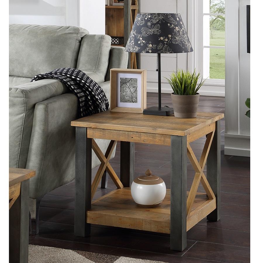 Brown reclaimed wood lamp table with a rustic design, featuring metal accents, an open shelf, and a decorative lamp with a floral shade, complemented by a potted plant and a framed photo.
