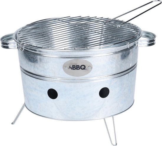 Portable round BBQ grill in silver metal, measuring 38x20cm, featuring a wire cooking grate, two handles, and three air vents for ventilation.
