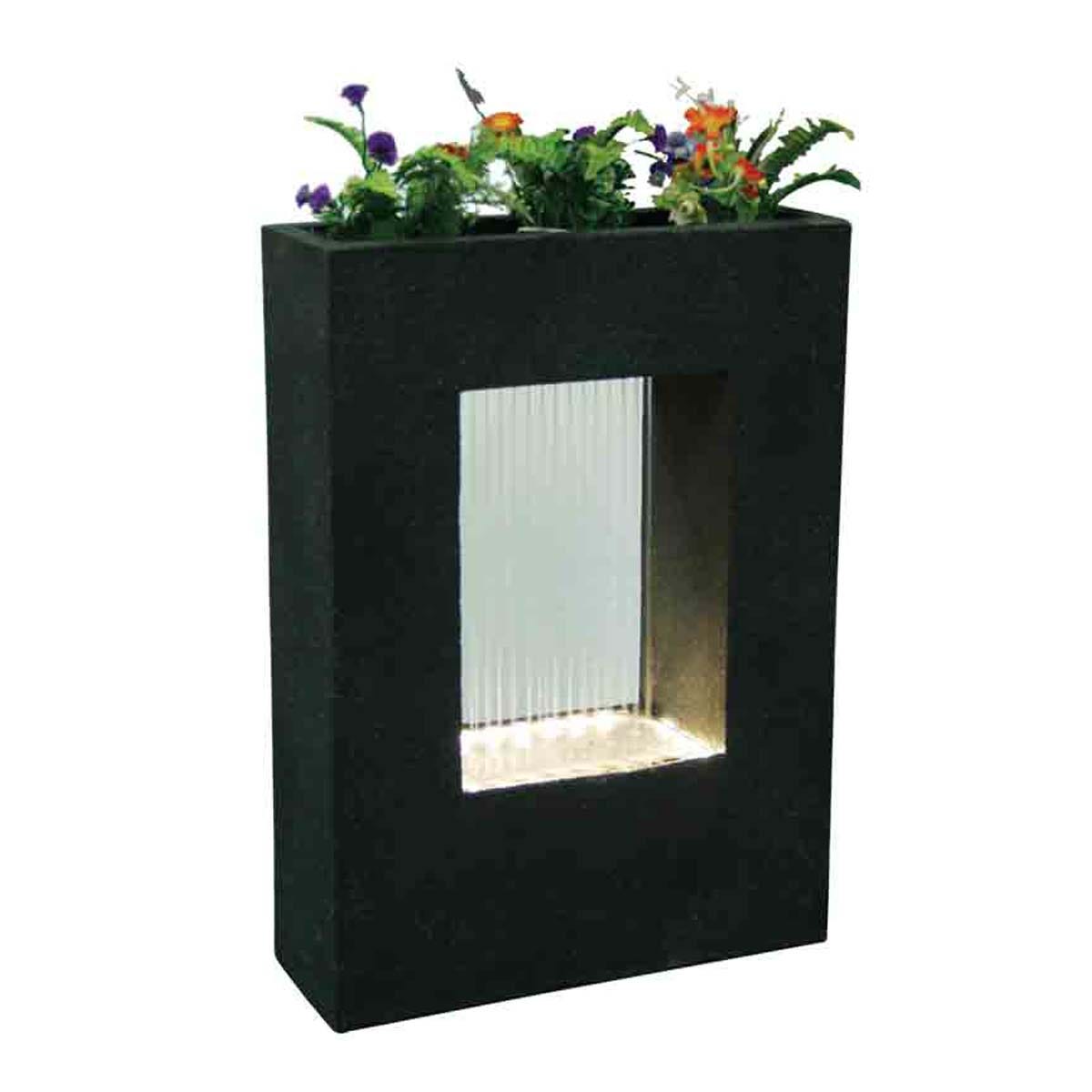 Sleek black water feature with a rectangular design, featuring a clear water flow panel, illuminated base, and a planter on top with colorful flowers.