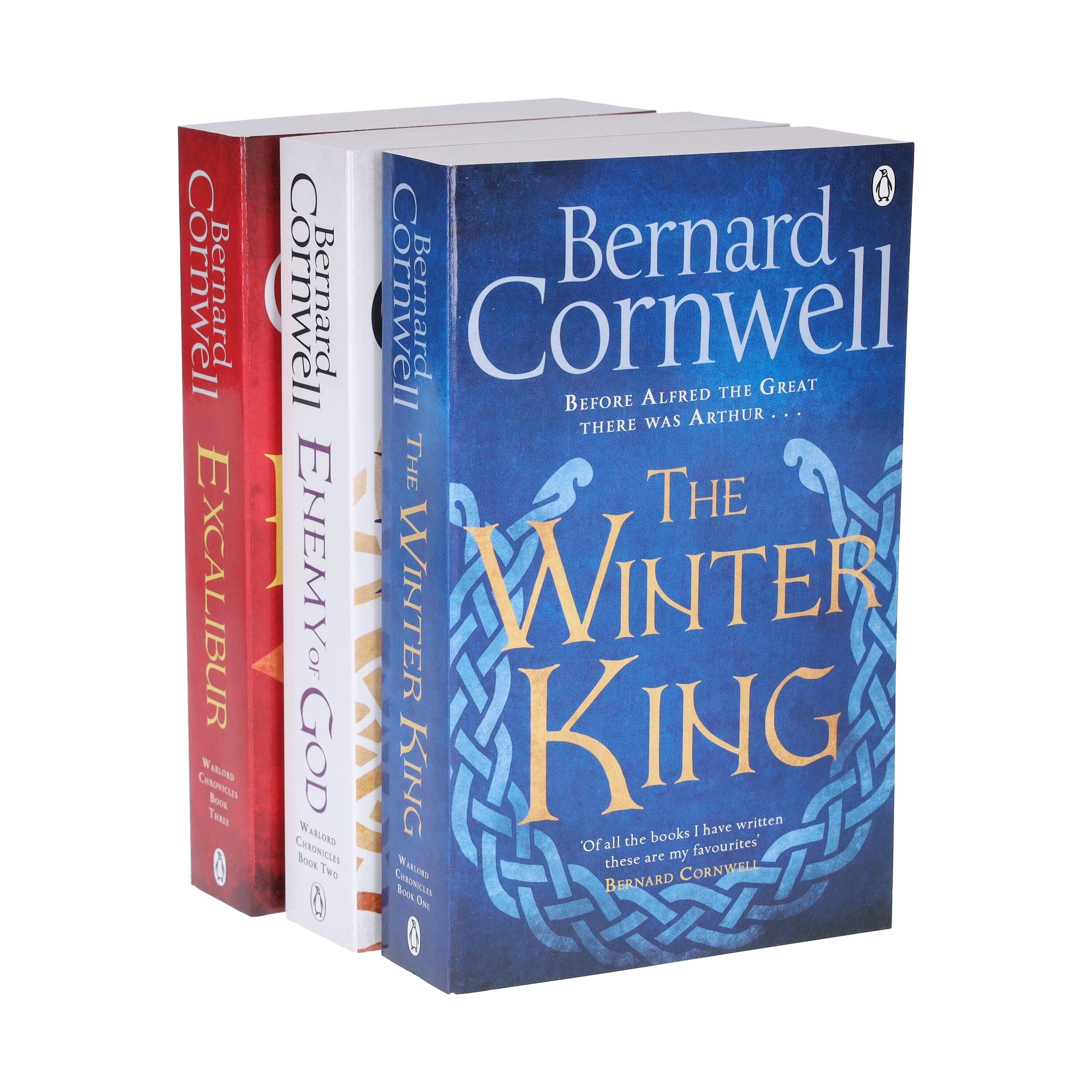 Three paperback books in a collection by Bernard Cornwell: "Excalibur" in red, "Enemy of God" in white, and "The Winter King" in blue with a Celtic knot design on the cover.