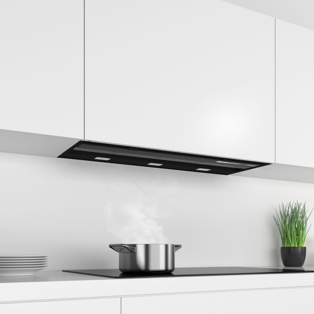 Bosch DBB97AM60B Series 6 90cm flush design hood in sleek black glass, mounted above a modern kitchen countertop with a pot emitting steam and a small plant nearby.
