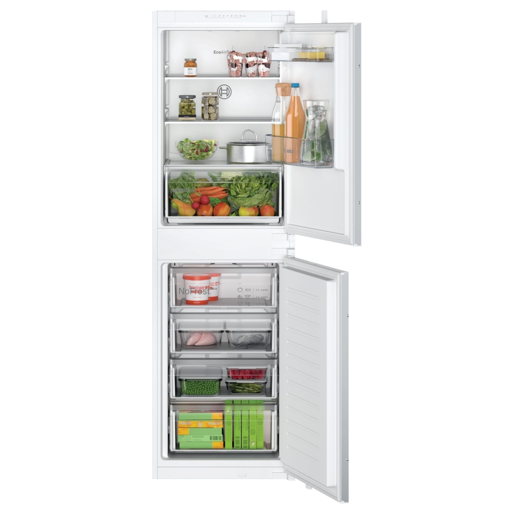 Bosch 54.1cm integrated frost-free fridge freezer in white, featuring clear shelves, organized compartments, and fresh produce, with a bottom freezer section containing various frozen items.