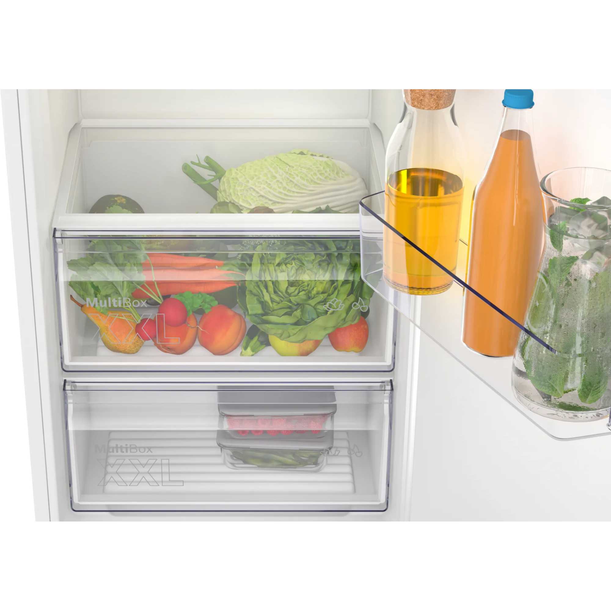 Integrated Bosch Series 2 fridge with 310 litres capacity, featuring clear drawers filled with vegetables and fruits, and a transparent shelf holding bottles and jars.