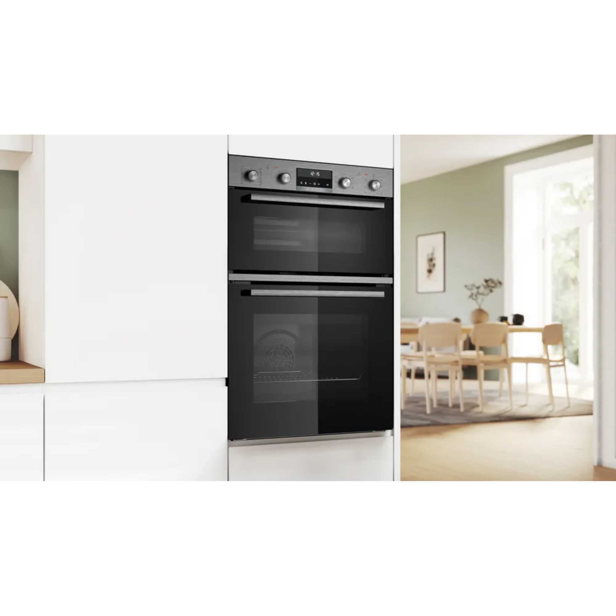 Stainless steel Bosch Series 6 built-in double oven with a sleek black glass front, featuring digital controls and two spacious oven compartments.