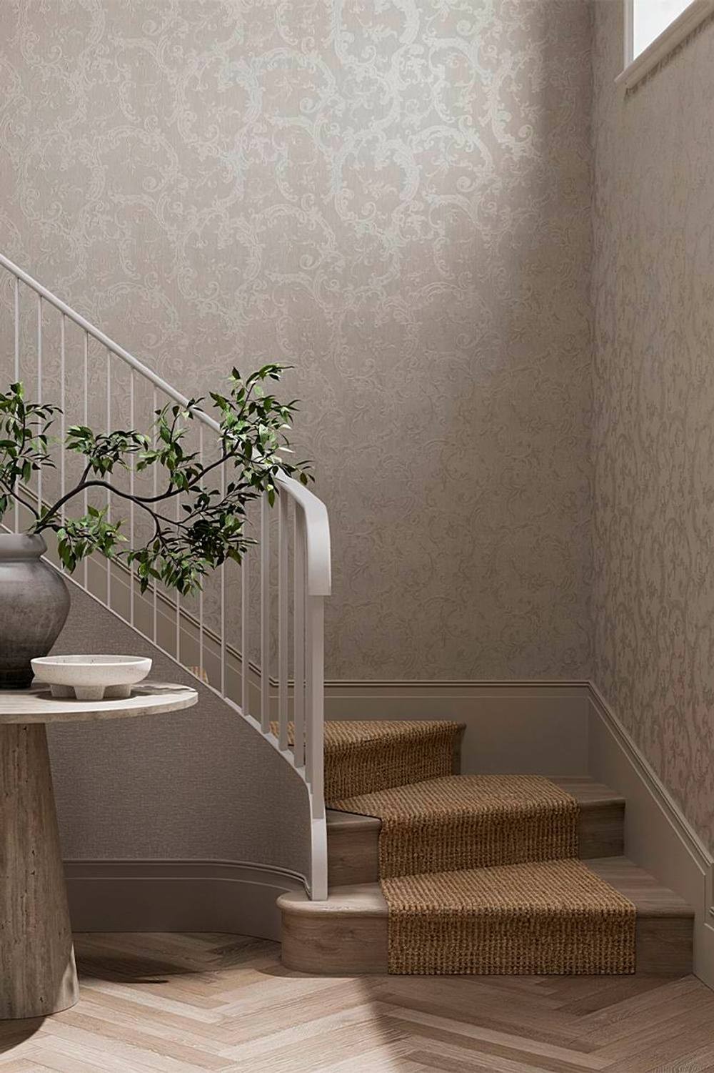 Boutique Florentine Earth Wallpaper in Grey features an intricate damask pattern on a soft grey background, complementing a staircase with a woven runner and a potted plant.