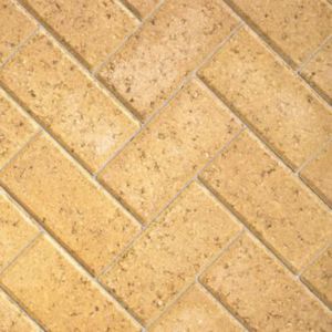 Autumn-colored concrete block paving in a herringbone pattern, featuring rectangular blocks measuring 200mm x 100mm x 50mm, with a textured surface.