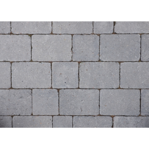 Gray rumbled concrete block paving with a textured surface, featuring rectangular blocks measuring 100mm x 134mm x 50mm, arranged in a staggered pattern.