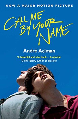 A paperback book cover featuring the title "Call Me by Your Name" in bright yellow text, with a blue background and an image of two young men gazing upwards.