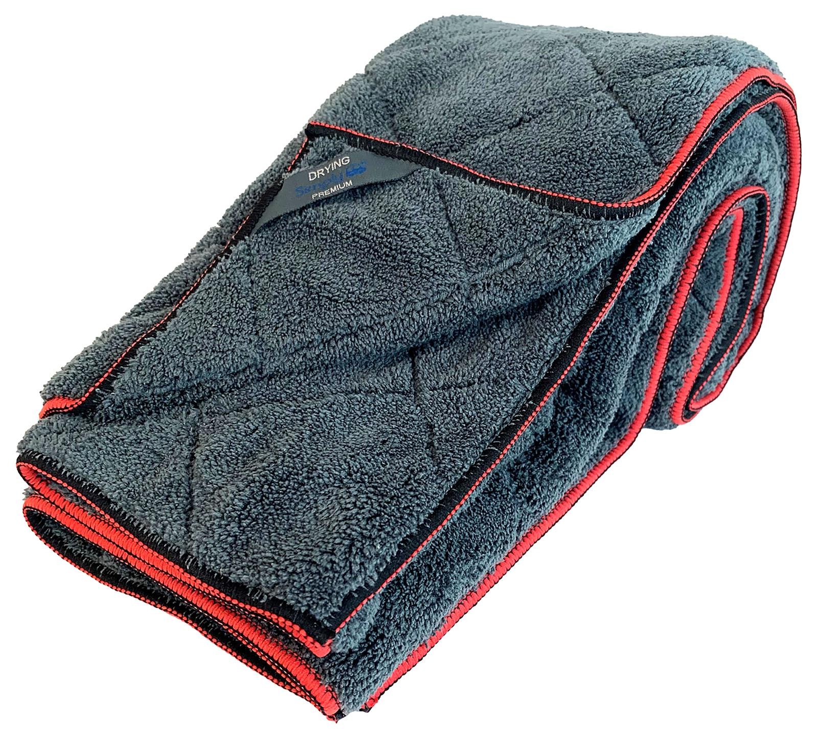 Soft, dark gray microfiber drying towel with a quilted texture, featuring red stitching and a label that reads "Simply Plush Drying Towel" by Carkit.
