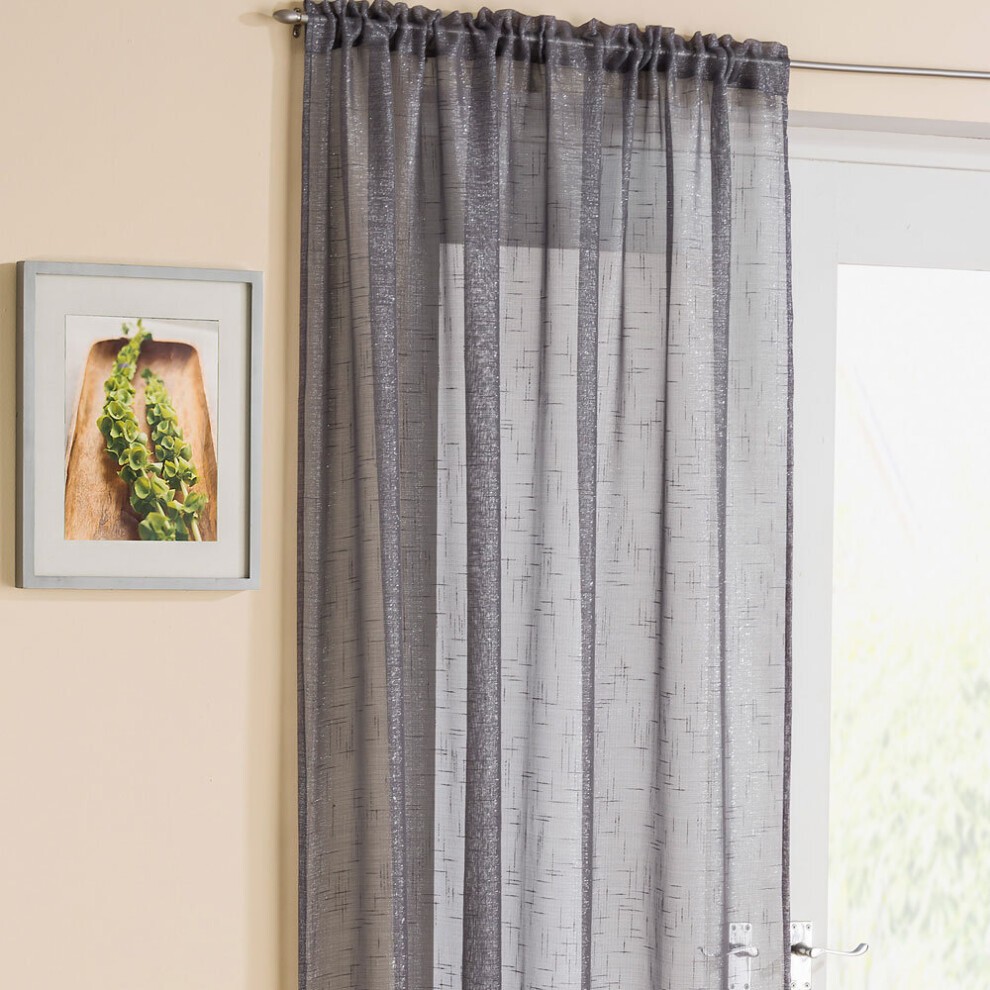 Grey metallic yarn voile curtain panel measuring 54 x 48 inches, featuring a slot top design and a subtle textured pattern, hanging beside a framed picture.