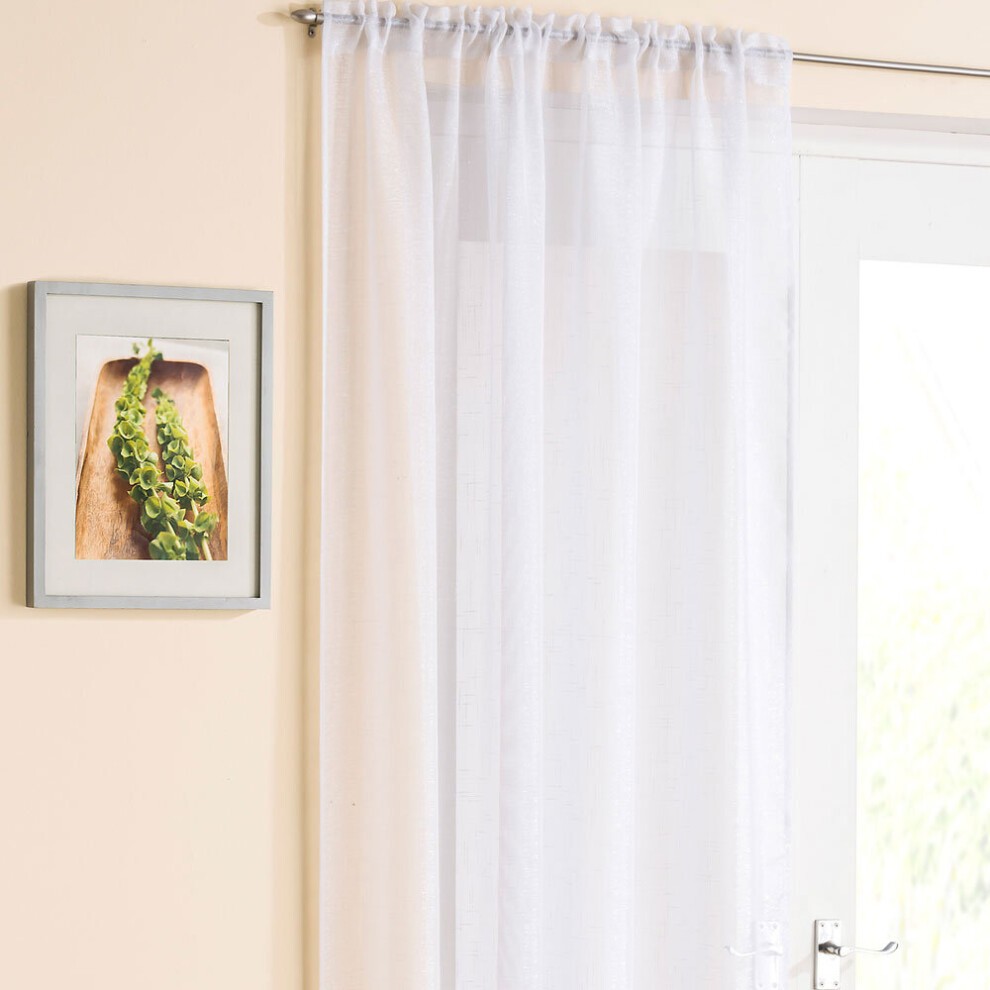 White sheer panel by Tyrone Textiles, featuring a lightweight, translucent fabric that softly filters light, hanging from a silver curtain rod next to a framed plant photo.