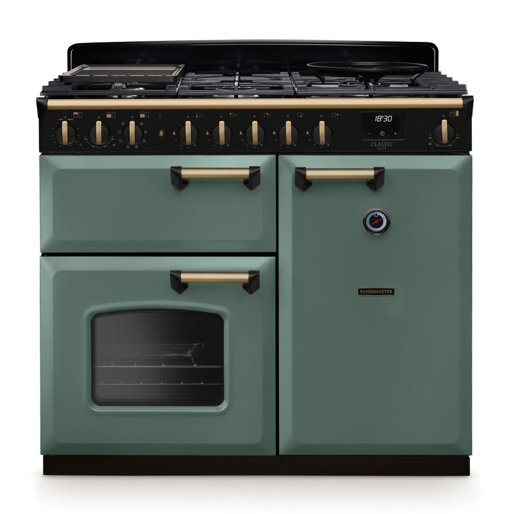 Classic Deluxe 100cm dual fuel range cooker in mineral green with antique brass accents, featuring six burners, a large oven, and stylish control knobs.