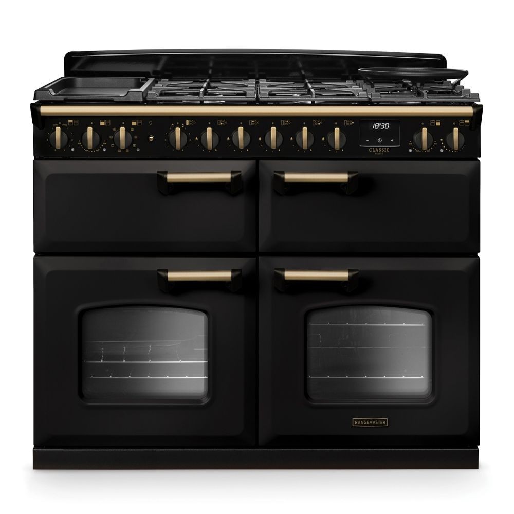 Classic Deluxe 110cm dual fuel range cooker in charcoal black with antique brass accents, featuring five gas burners, a griddle, and two large glass-fronted ovens.
